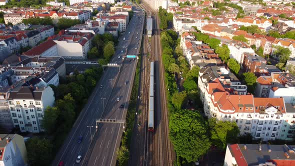 Subway train enters the station next to the Berliner Ring.Marvelous aerial view flight hover drone