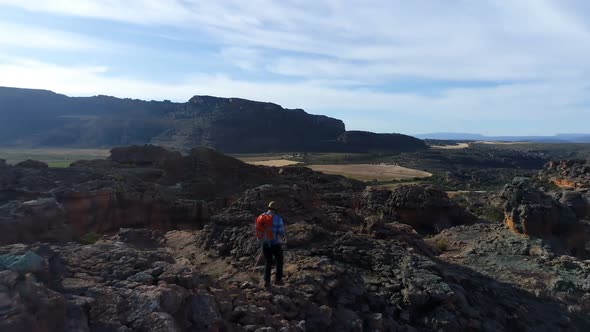 Male rock climber walking over a rocky mountain 4k