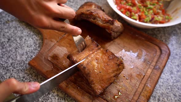 Person cutting Argentinean style grilled meat