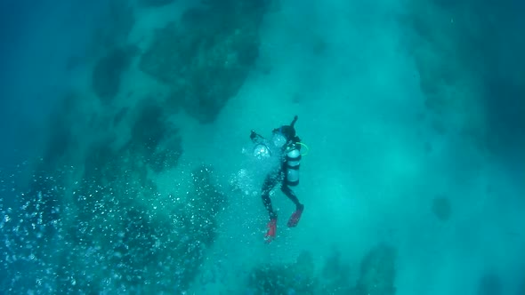 Many bubbles coming up from a scuba diver swimming in the ocean
