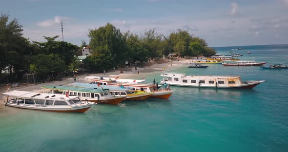 Traditional Indonesian boats moored on tropical Gili Island beach, aerial
