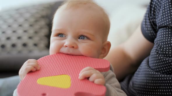 Baby Boy Chewing His Colourful Toy