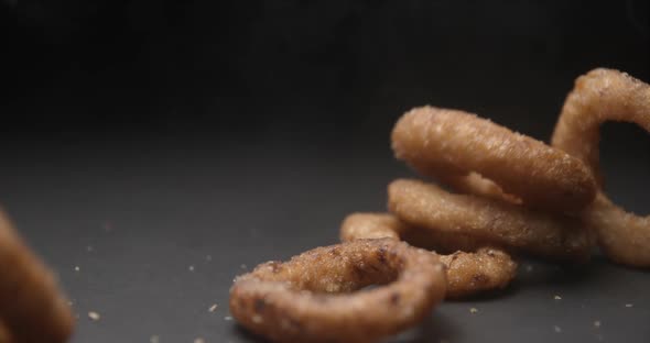 Onion rings close up slow motion studio, tasty fast food