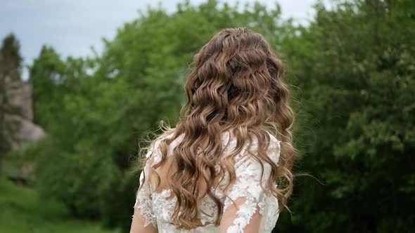 Beautiful Bride in Fashion Wedding Dress on Natural Background