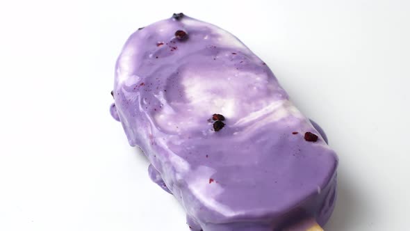 Lavender purple cold ice cream melt on white background. 4K video of ice cream.