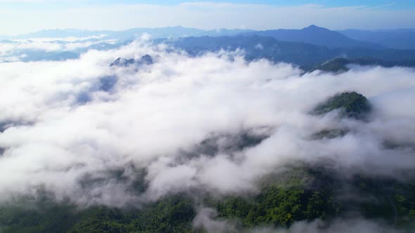 An aerial view from a drone flying over the many fogs in the mountains