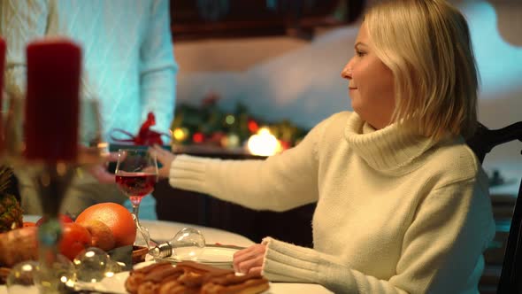 Ungrateful Woman Rejecting Gift Box Looking at Camera with Annoyed Facial Expression