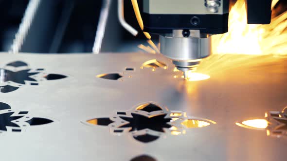 Industrial Laser Machine Cuts Metal Parts from Sheets. Sparks Fly to The Side