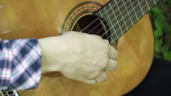 Woman's Hands Playing Acoustic Guitar.