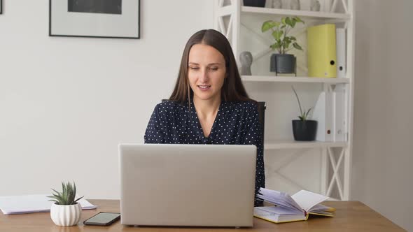 Smiling Female Employee Closing Up Laptop and Rests