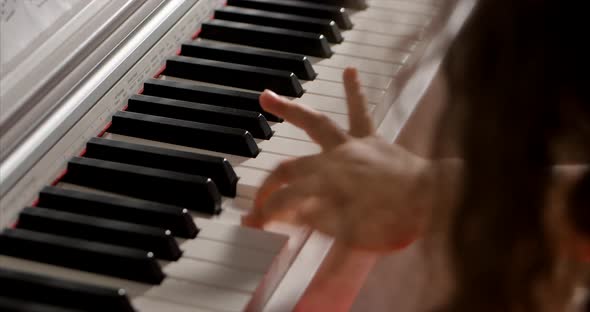 Little Baby Girl or Child Professional Pianist Plays Classical Music on a Beautiful White Piano a