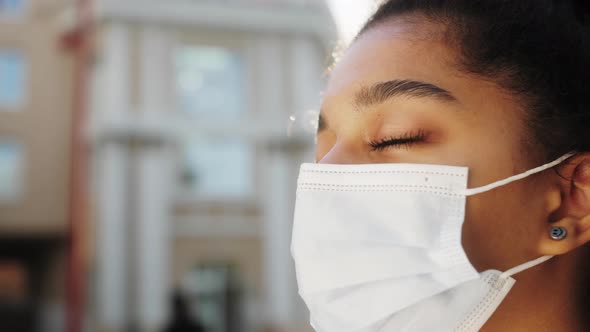 African Ethnic Teenage Girl Takes Off Protective Medical Mask Smiles Breathes in Deeply Rejoices at