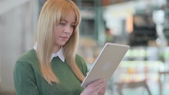 Portrait of Young Woman Using Tablet in Office