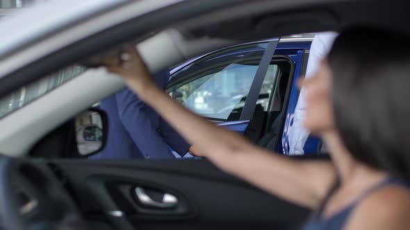 Buyers Testing Cars From Inside at Auto Showroom