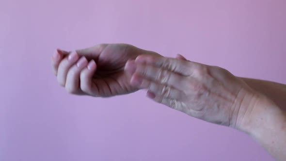 Hands of a Young Woman Applying Hand Cream Hands Massage