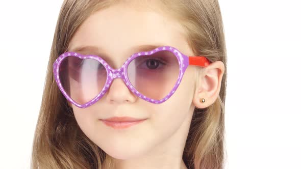 Child Posing for Video Cameras with Glasses. White Background. Close Up