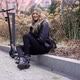 Happy Female with Electric Scooter Resting in Autumn Park - VideoHive Item for Sale