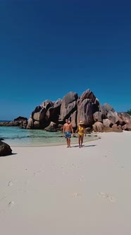 Men and Women on the Beach of Anse Cocos La Digue Seychelles Tropical Beach During Luxury Vacation