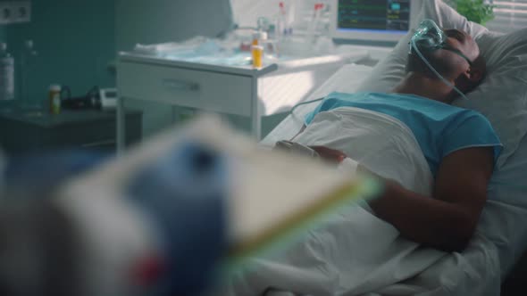 Sick Patient with Oxygen Mask Lying Bed