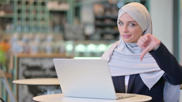Thumbs Down By Arab Woman Working on Laptop