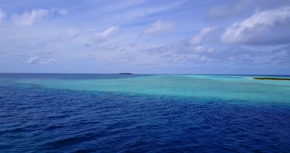 Tropical fly over abstract shot of a paradise sunny white sand beach and blue sea background 