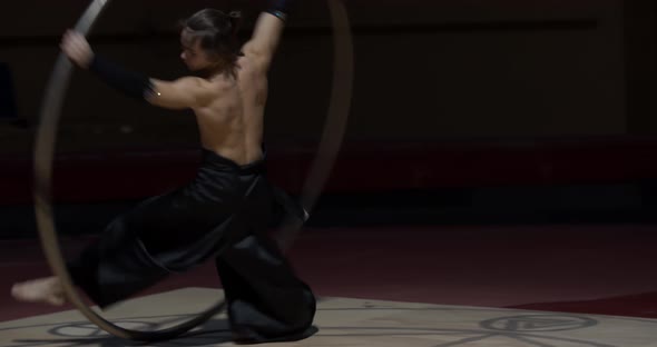 Circus Artist Is Doing Wheel Gymnastics Training Before the Performance