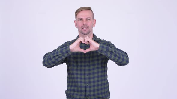 Portrait of Happy Blonde Hipster Man with Hand Heart Gesture