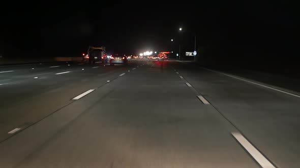 View From the Car. Los Angeles Busy Freeway at Night Time. Massive Interstate Highway Road in