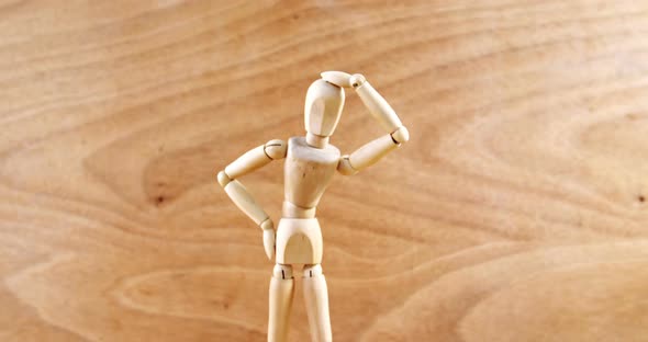 Figurine standing with hand on head