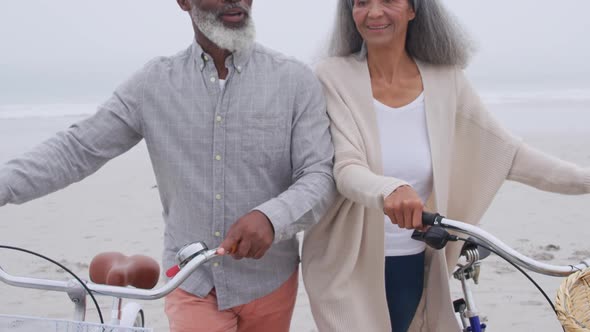 Mature couple enjoying time outside by the sea