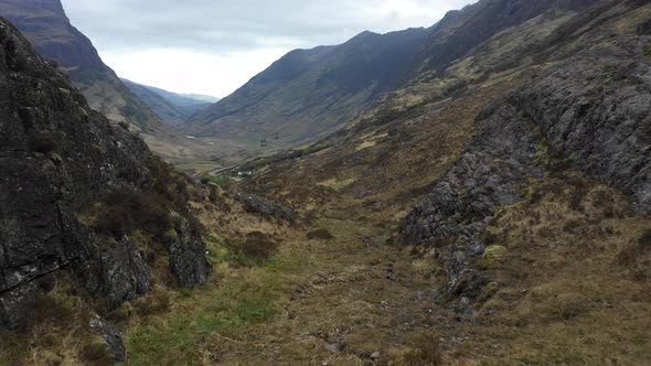 Aerial view of a valley in the Highlands with a road that winds through the m