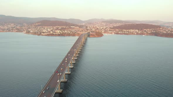 Hobart, Aerial shot over Tasman bridge highway at sunset. (Drone footage)