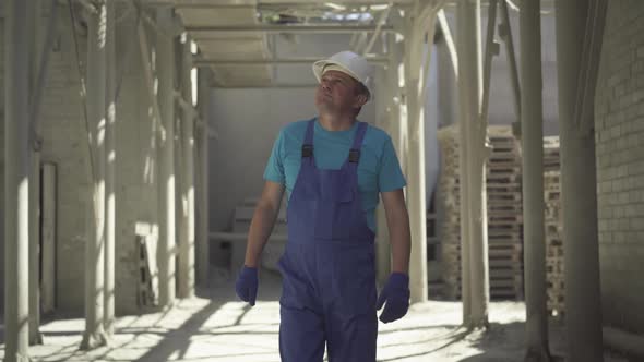 Male Caucasian Inspector Checking Building Site Outdoors. Portrait of Confident Professional Man