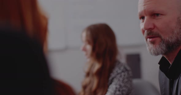 Businessman Discussing with Colleague in Meeting