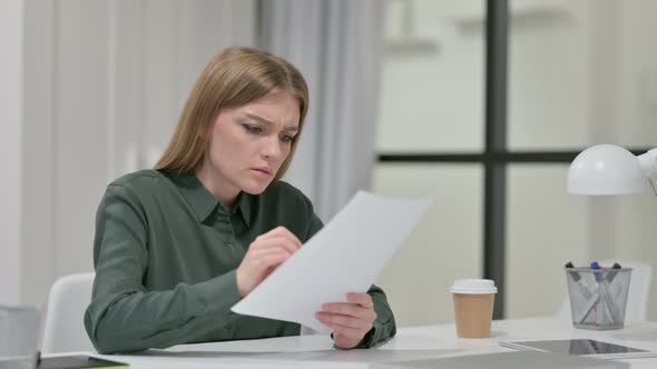 Young Woman Upset By Loss on Documents 