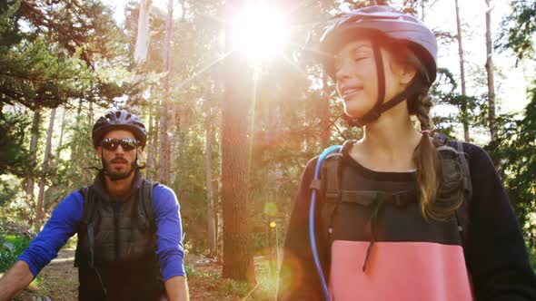 Mountain biking couple pointing at nature