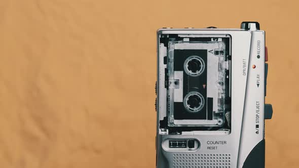 Portable Retro Tape Recorder with Micro Cassette Rec Sound on Yellow Background