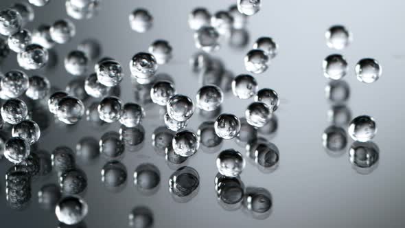 Super Slow Motion Shot of Hydrogel Balls Bouncing on Glass at 1000Fps