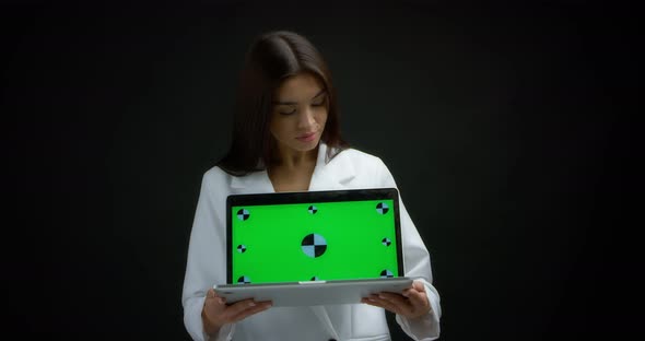 Woman Holding Laptop with Chroma Key Mockup Blank Screen