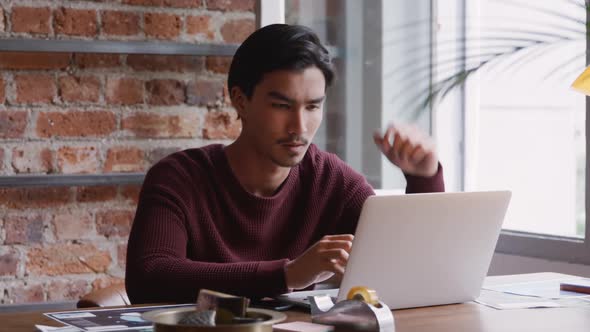 Mixed race man concentrated and working in his house