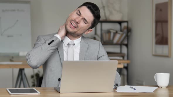 Tired Businessman with Neck Pain at Work