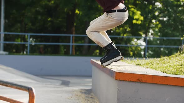 Aggressive Inline Roller Skater Doing Tricks in Concrete Skatepark Outdoors with Beautiful