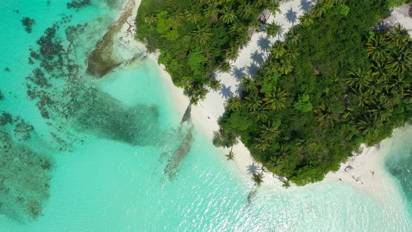 Luxury aerial travel shot of a sunshine white sandy paradise beach and blue water background 