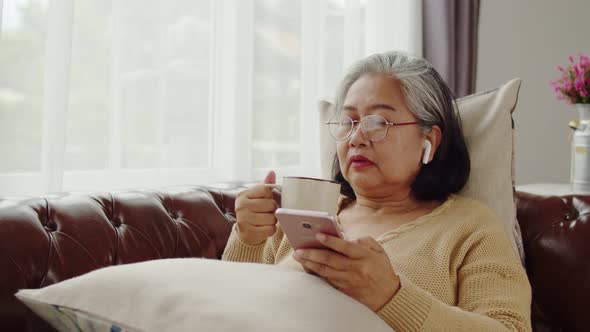 Senior woman listening music with happiness at home