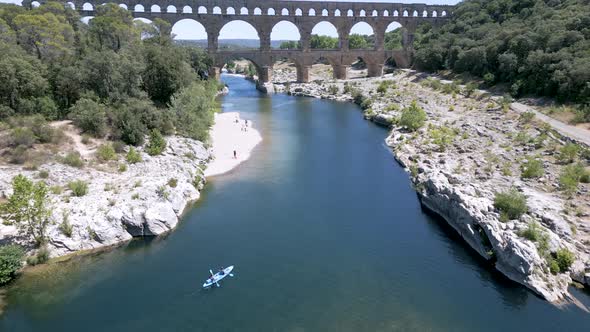 Drone approaching The Pont du Gard, an ancient Roman aqueduct bridge in France