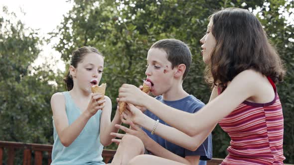 Kids eating Ice Cream together, enjoying and laughing