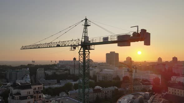 Construction Crane on a Construction Site in the City at Sunrise. Kyiv, Ukraine. Aerial View