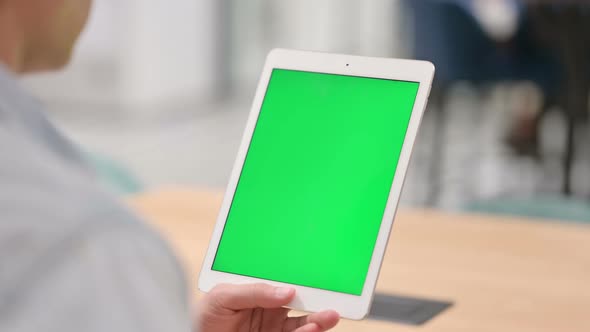 Man Using Tablet with Green Chroma Key Screen