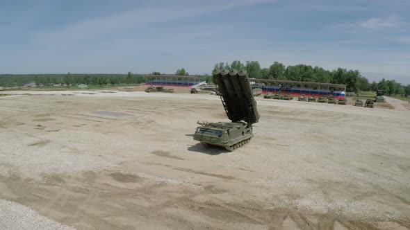 Flying over missile launcher and tanks on shooting-ground