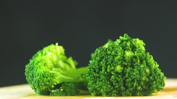 Close-up of raw broccoli on a kitchen board rotate. Preparing fresh broccoli.